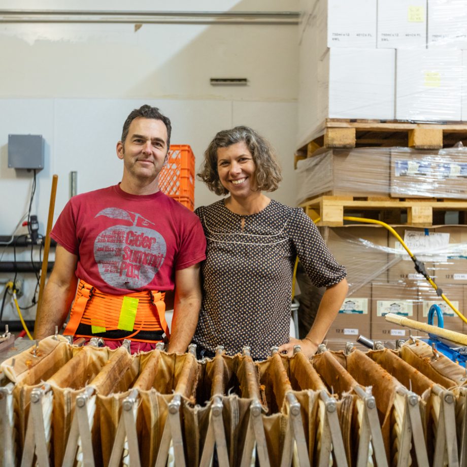 The owners of Tilted Shed smiling in their kitchen